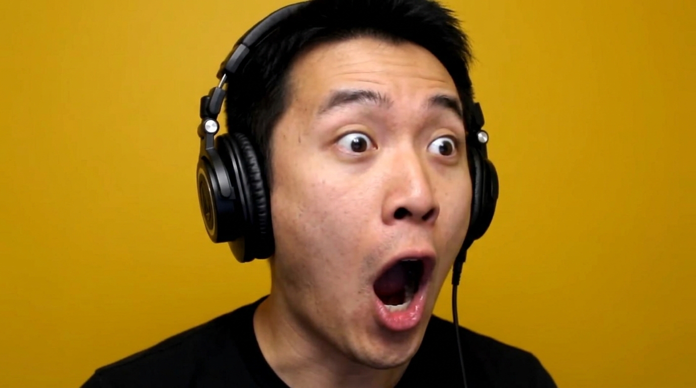 Man wearing studio headphones with a shocked expression, representing game-changing podcast production tips.